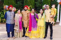 Gorgeous Indian bride and groom posing outdoors with family. Gorgeous Indian bride and groom posing outdoors with family.