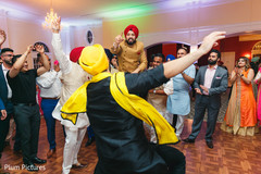 Indian groom being lifted by groomsmen at sangeet. Indian groom being lifted by groomsmen at sangeet.