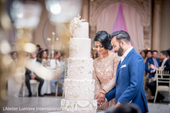Lovely capture Indian bride and groom cutting cake together. Lovely capture Indian bride and groom cutting cake together.
