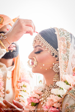 Red mark applied on bride's forehead by groom. Red mark applied on bride's forehead by groom.