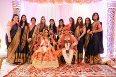 Bridesmaids posing with the joyful couple Bridesmaids posing with the joyful couple