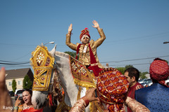 Indian groom riding the horse during the Baraat Indian groom riding the horse during the Baraat