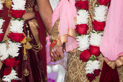 Lovely shot of Indian bride and groom holding hands Lovely shot of Indian bride and groom holding hands