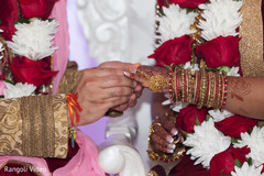 Indian bride receiving the ring during the ceremony Indian bride receiving the ring during the ceremony