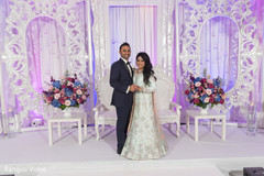 Indian couple posing for pictures by the decor Indian couple posing for pictures by the decor