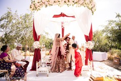 Indian bride putting flower garland to groom. Indian bride putting flower garland to groom.