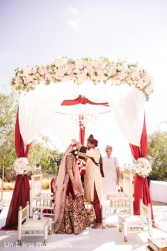 Indian groom putting flower garland to bride. Indian groom putting flower garland to bride.