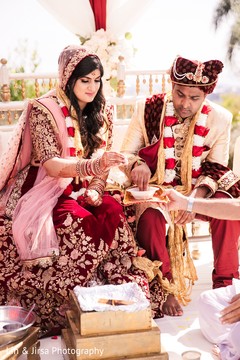 Lovely Indian bride and groom getting food during wedding ceremony. Lovely Indian bride and groom getting food during wedding ceremony.