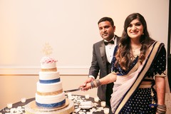 Indian wedding reception cutting the cake moment. Indian wedding reception cutting the cake moment.