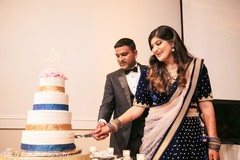 Lovely capture Indian bride and groom cutting cake together. Lovely capture Indian bride and groom cutting cake together.