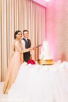 Cheerful Indian bride and groom cutting the cake. Cheerful Indian bride and groom cutting the cake.