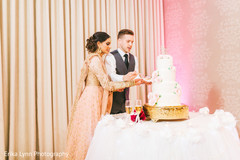 Lovely capture Indian bride and groom cutting cake together. Lovely capture Indian bride and groom cutting cake together.