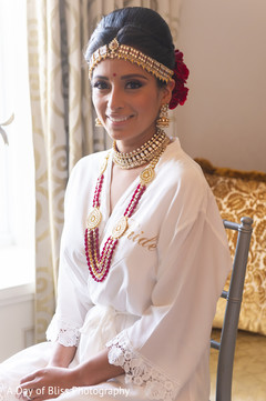 Indian bride wearing the jewelry prior to the ceremony Indian bride wearing the jewelry prior to the ceremony
