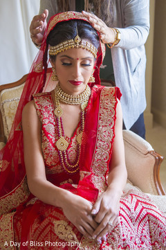 Indian bride being assisted by makeup artist Indian bride being assisted by makeup artist