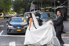 Indian groom holding Maharani's gown outdoors Indian groom holding Maharani's gown outdoors
