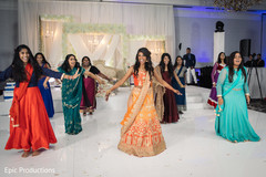 Joyful Indian bride and bridesmaids at reception dance performance. Joyful Indian bride and bridesmaids at reception dance performance.