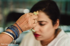Maharani getting turmeric paste on her face. Maharani getting turmeric paste on her face.