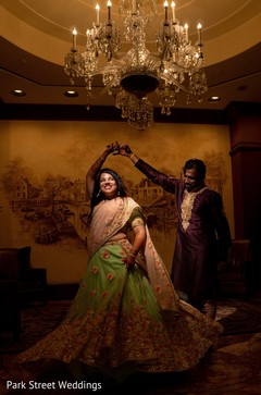 Indian bride and groom celebrating sangeet with a dance. Indian bride and groom celebrating sangeet with a dance.
