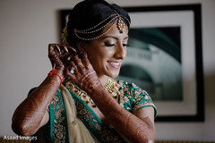 Lovely Indian bride putting her earrings on. Lovely Indian bride putting her earrings on.