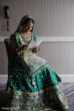 Enchanting Indian bride reading gooms card. Enchanting Indian bride reading gooms card.