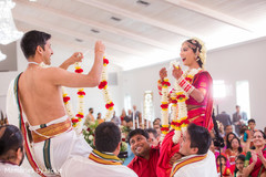 Indian bride and groom about to place the garland on each other Indian bride and groom about to place the garland on each other
