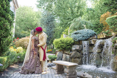 Capture of Indian bride and groom kissing by the water Capture of Indian bride and groom kissing by the water