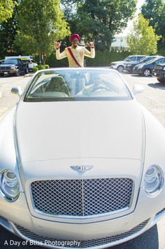 Indian groom making his entrance with the car Indian groom making his entrance with the car