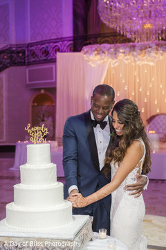 Indian groom and bride cutting the wedding cake Indian groom and bride cutting the wedding cake