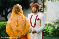 Sweet Indian bride's and groom's first look scene. Sweet Indian bride's and groom's first look scene.