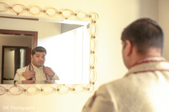 Indian groom fixing his dupatta. Indian groom fixing his dupatta.