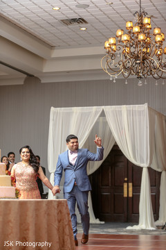 Joyful Indian couple making their entrance to reception. Joyful Indian couple making their entrance to reception.