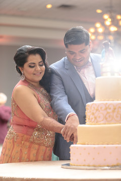 Indian lovebirds cutting cake moment. Indian lovebirds cutting cake moment.
