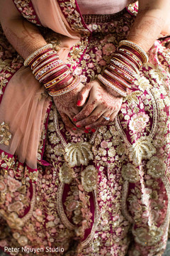 Indian bride showing her mehndi design and lengha Indian bride showing her mehndi design and lengha