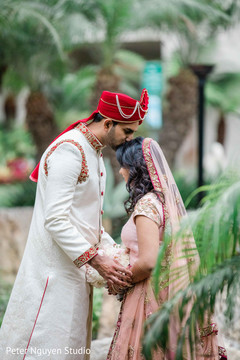 Indian groom kissing the Maharani outdoors Indian groom kissing the Maharani outdoors