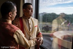 Indian groom being assisted by special guest Indian groom being assisted by special guest
