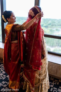 Indian bride being assisted by her mother Indian bride being assisted by her mother