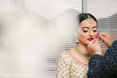 Beautiful Maharani being assisted with the bridal jewelry Beautiful Maharani being assisted with the bridal jewelry