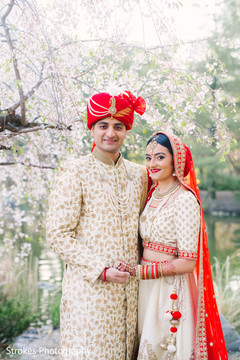 Indian bride holding hands with Raja outdoors Indian bride holding hands with Raja outdoors