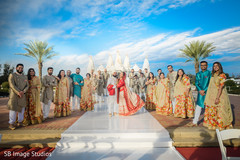 Indian couple taking pictures with bridesmaids and groomsmen Indian couple taking pictures with bridesmaids and groomsmen