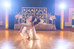 Indian bride and groom having their first dance Indian bride and groom having their first dance