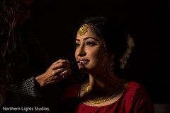 Indian bride getting her ceremony makeup done. Indian bride getting her ceremony makeup done.