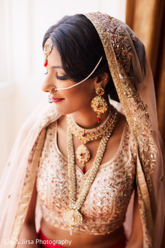 Indian bride posing with her jewelry prior to the ceremony Indian bride posing with her jewelry prior to the ceremony