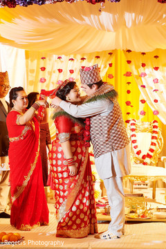 Indian groom placing the flower garland on Maharani Indian groom placing the flower garland on Maharani