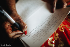 Closeup capture of Indian bride writing her vows. Closeup capture of Indian bride writing her vows.