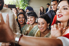 Indian bridesmaid performing a game with groomsmen at baraat. Indian bridesmaid performing a game with groomsmen at baraat.