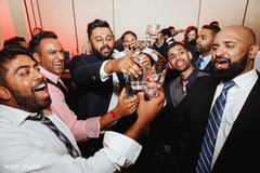 Indian groom and groomsmen making a toast. Indian groom and groomsmen making a toast.