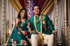 Joyful Indian couple in their sangeet swing seat. Joyful Indian couple in their sangeet swing seat.