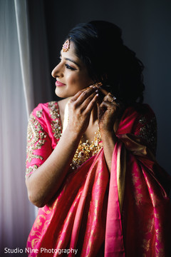 Indian bride getting her earrings on. Indian bride getting her earrings on.