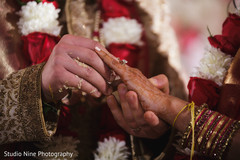 Indian groom putting wedding ring to bride. Indian groom putting wedding ring to bride.