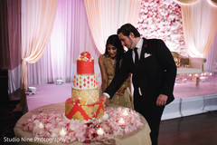Lovely capture Indian bride and groom cutting cake together. Lovely capture Indian bride and groom cutting cake together.